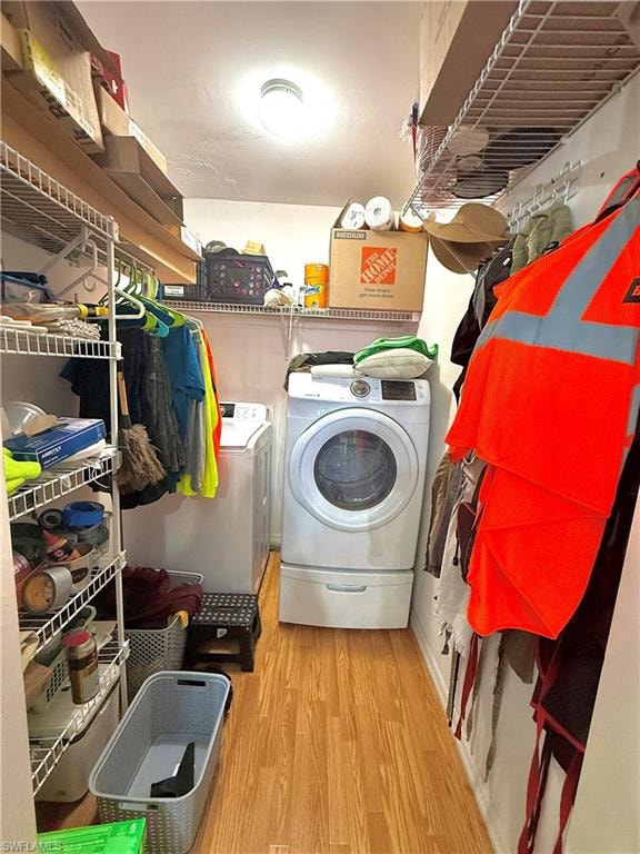 Laundry room featuring light wood-style flooring and washer and dryer