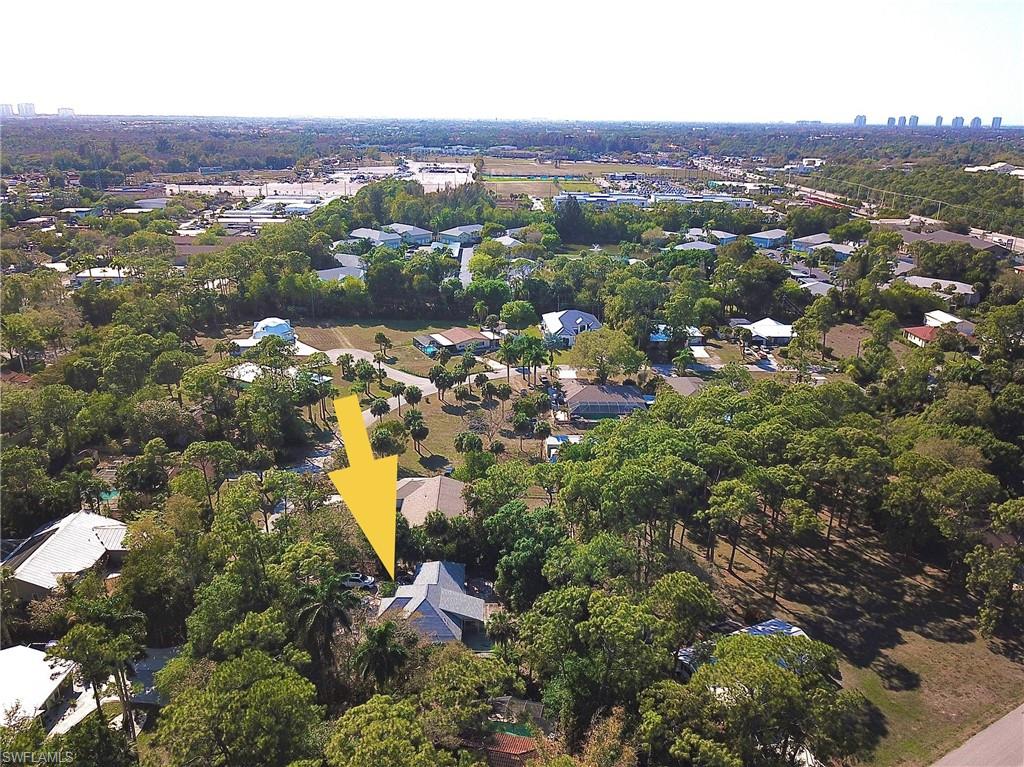 Aerial view of property's location with skyline and nearby suburban area