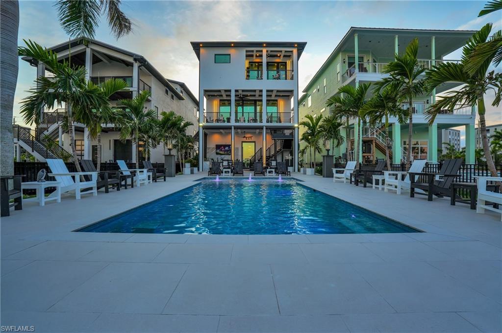 Swimming pool with stairs, a patio, and a balcony - Virtually Edited Image