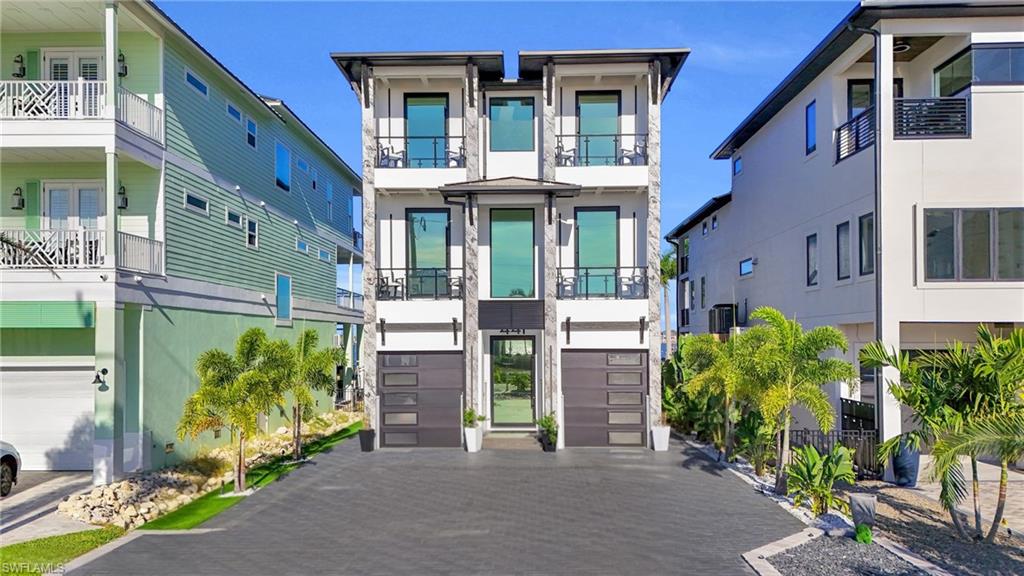 Modern home with an attached garage, driveway, and stucco siding - Virtually Edited Image