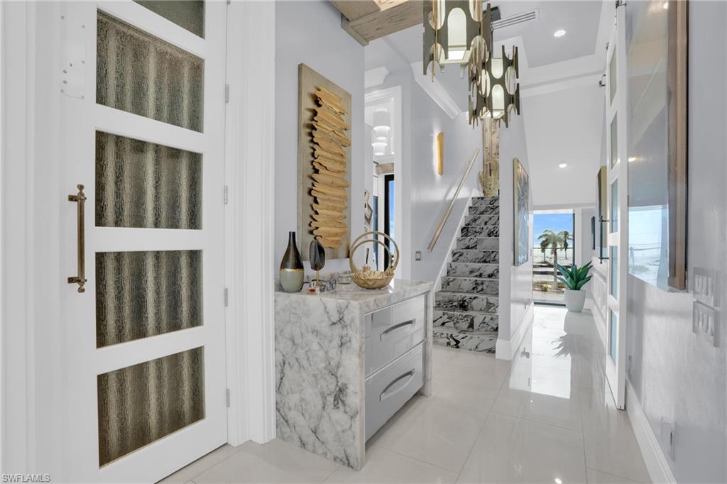 Foyer featuring stairway, light tile patterned floors, and recessed lighting - Virtually Edited Image