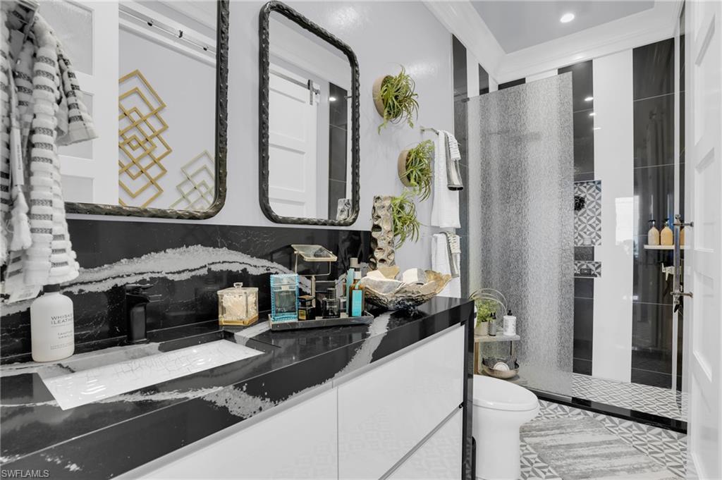 Full bath with a walk in shower, vanity, and crown molding - Virtually Edited Image