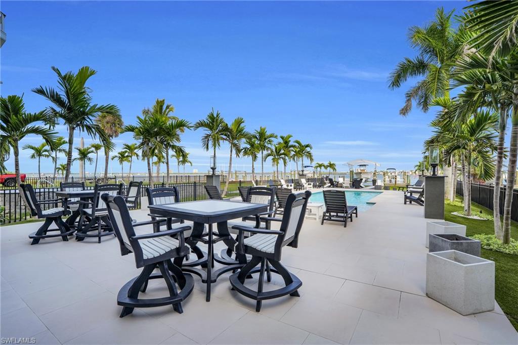 View of patio featuring a community pool - Virtually Edited Image