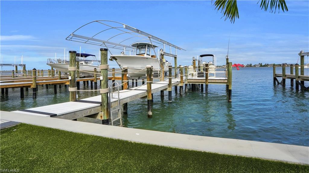 Dock area with boat lift and a water view - Virtually Edited Image