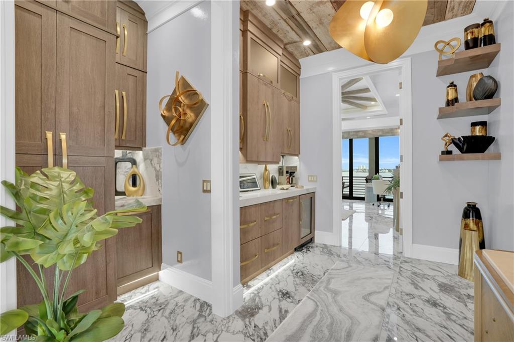 Hallway featuring light marble finish floors, recessed lighting, and beverage cooler - Virtually Edited Image