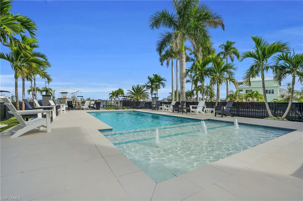 Community pool featuring a patio area - Virtually Edited Image