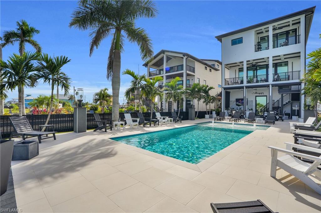 View of swimming pool with a patio and stairway - Virtually Edited Image