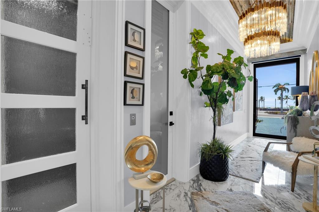 Entryway with marble tiled floors and a chandelier - Virtually Edited Image