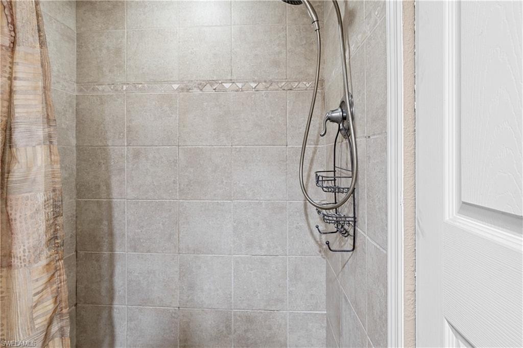 Bathroom view of a tile shower