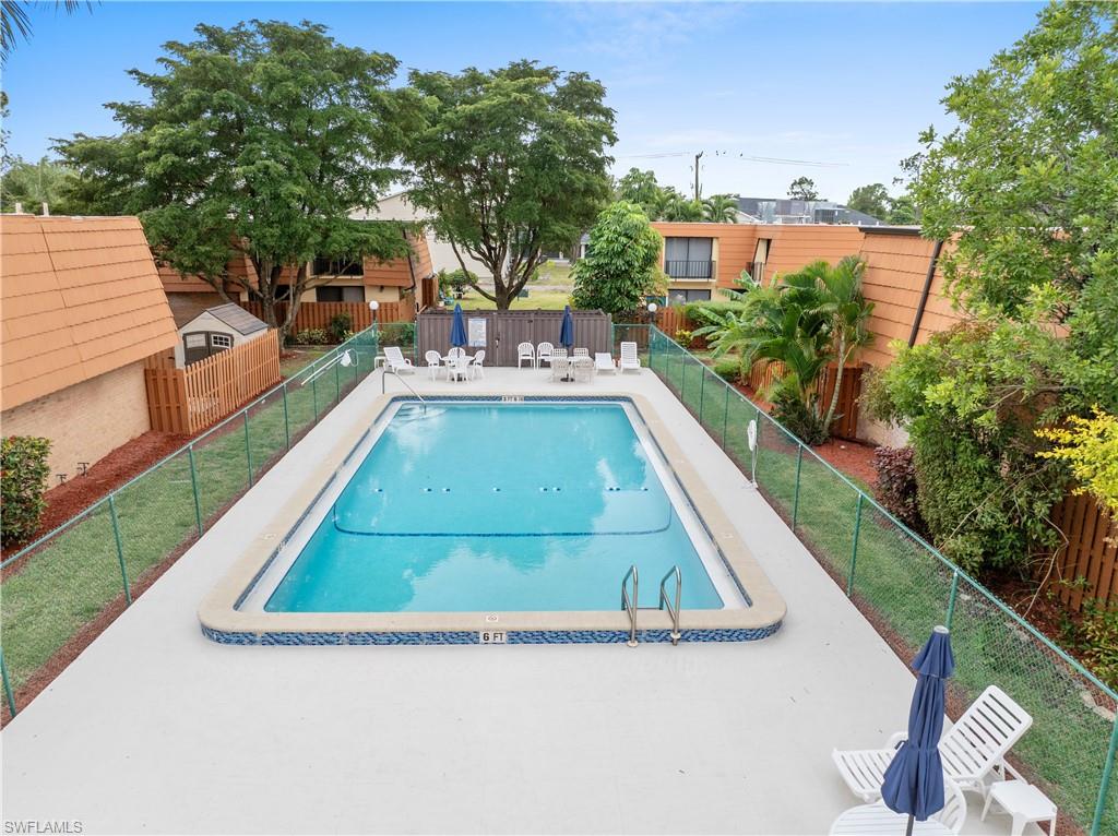 Community pool featuring a patio and a fenced backyard