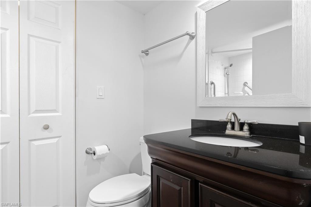 Bathroom with vanity, a closet, and a shower