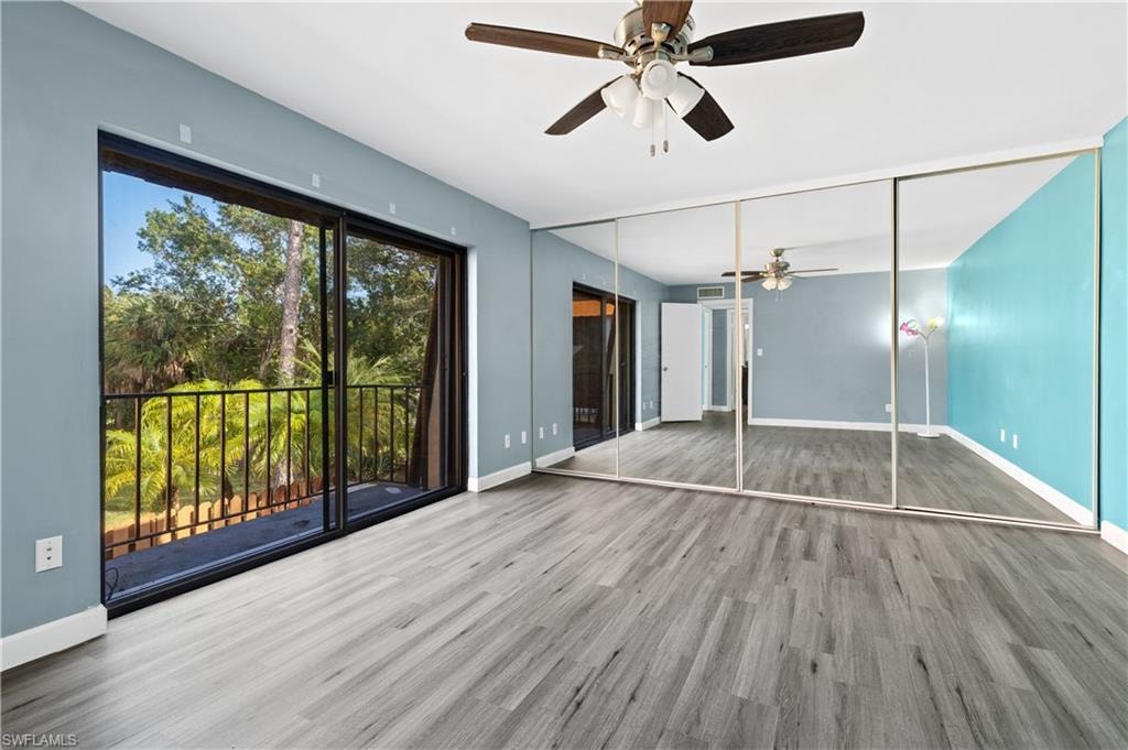 Unfurnished living room featuring ceiling fan and wood finished floors