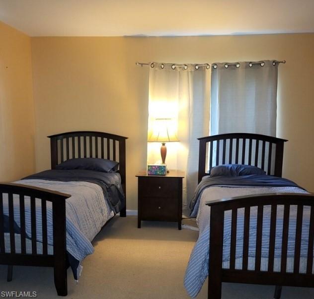 Bedroom with light carpet