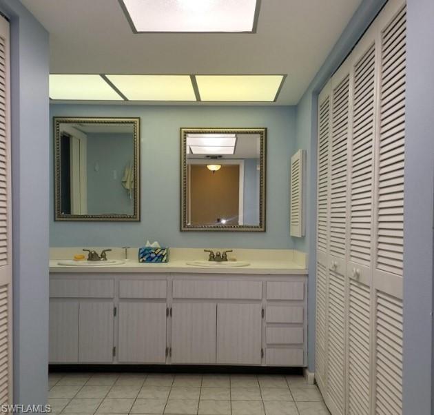 Bathroom featuring tile patterned flooring and vanity