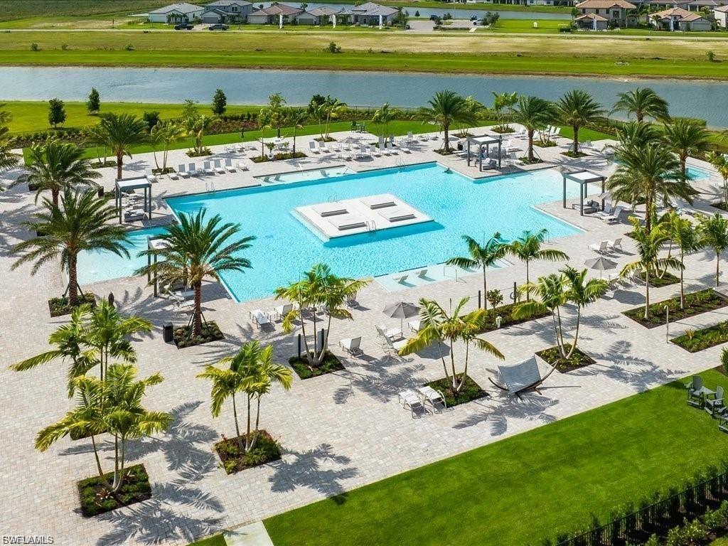 Community pool featuring a water view, a yard, and a patio area