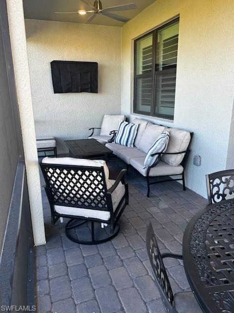 Balcony with outdoor lounge area and ceiling fan