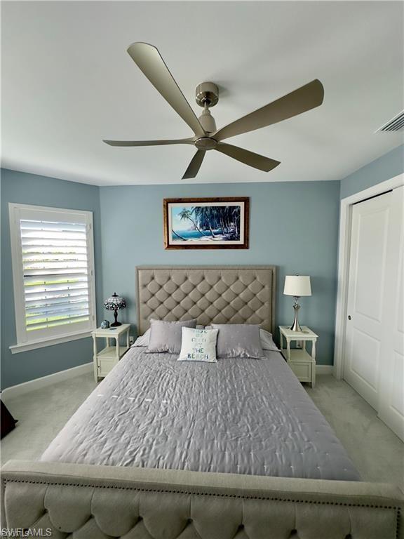 Bedroom featuring a closet, a ceiling fan, and carpet flooring