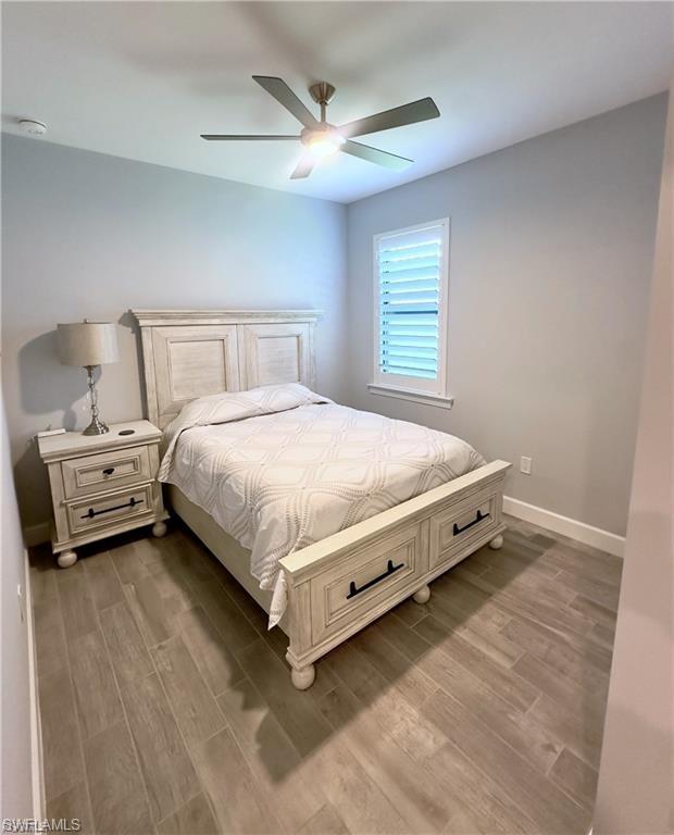 Bedroom featuring wood finished floors and a ceiling fan