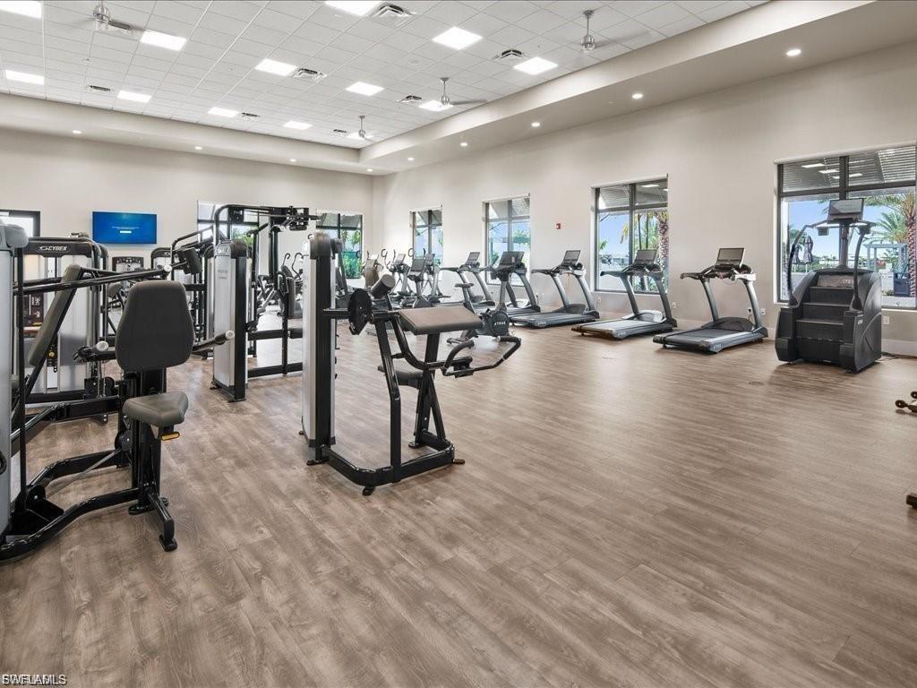 Exercise room with a towering ceiling and a drop ceiling