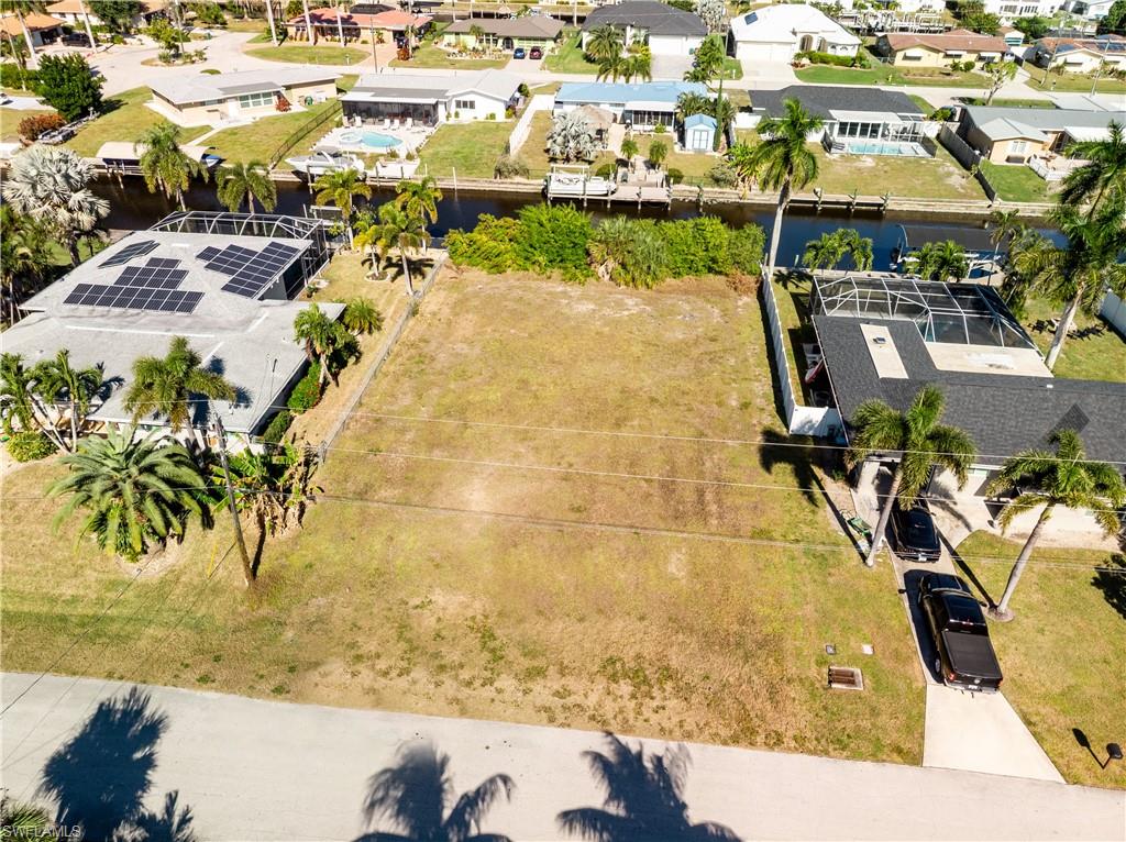 Aerial perspective of suburban area featuring a nearby body of water