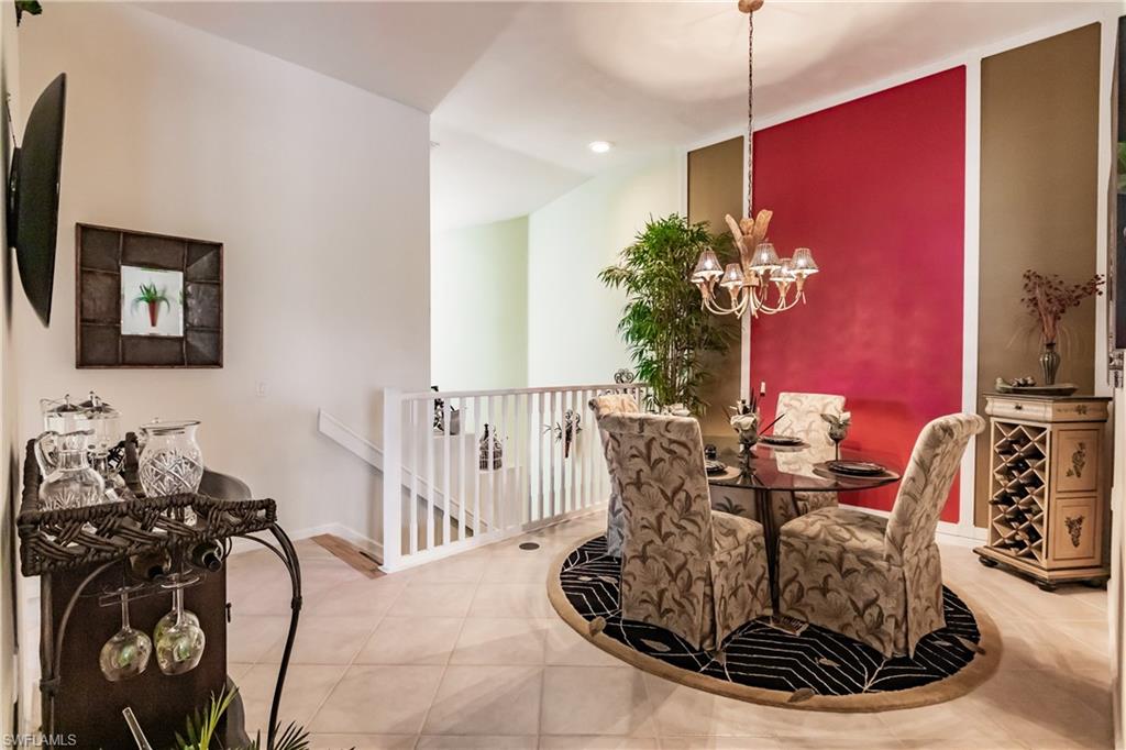 Dining room featuring light tile patterned floors, recessed lighting, and a chandelier