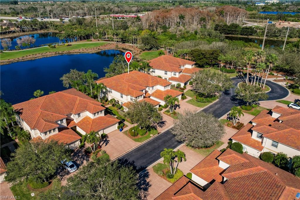 Aerial perspective of suburban area featuring a large body of water