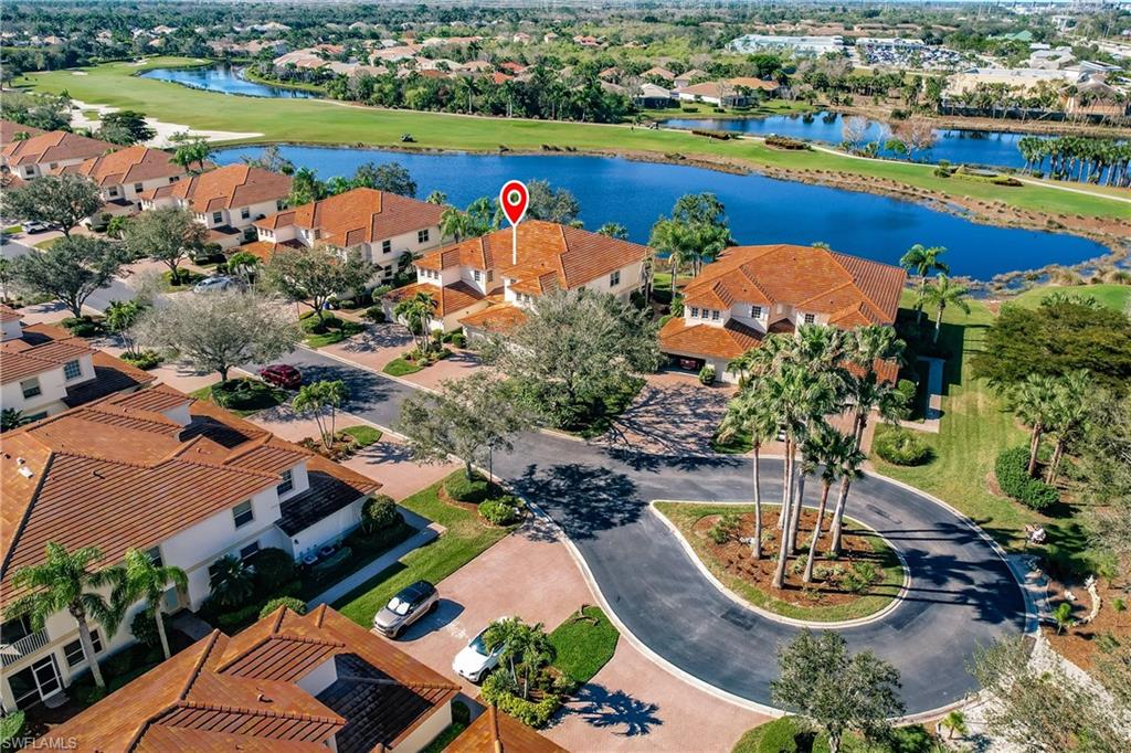 Aerial perspective of suburban area featuring a large body of water and a local golf course