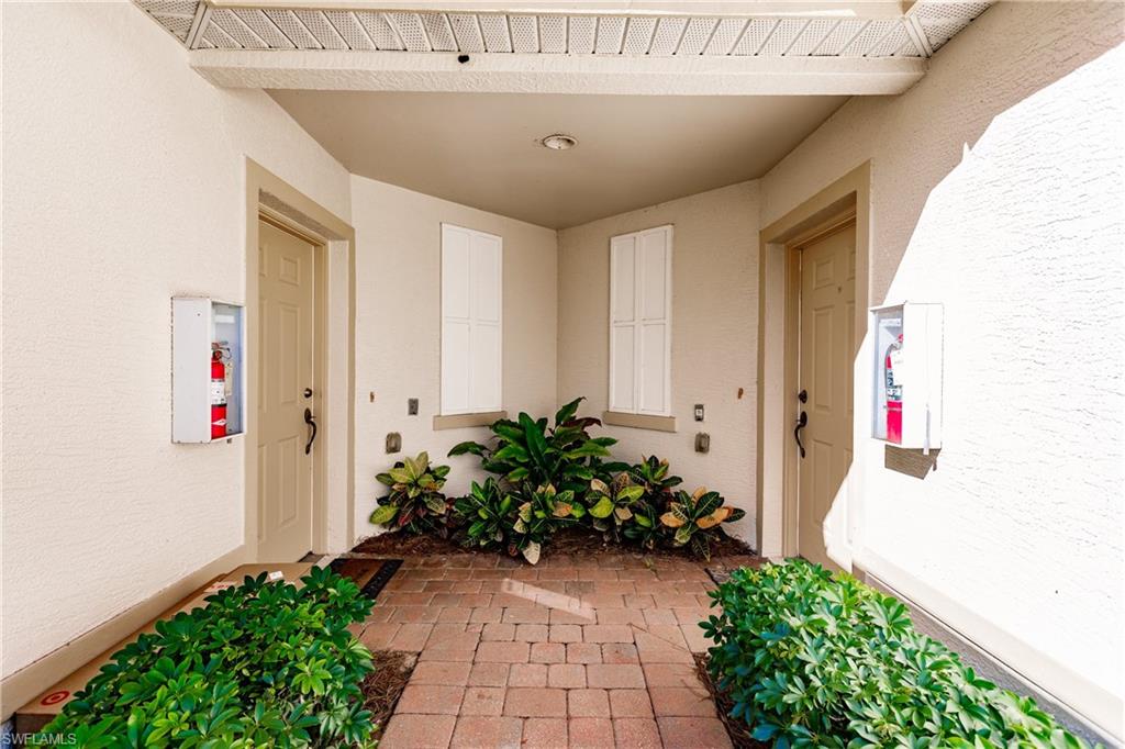 Doorway to property with stucco siding