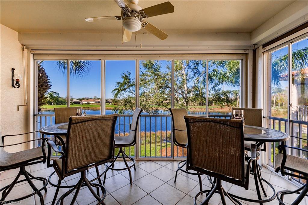 Sunroom / solarium featuring a water view and tile patterned floors