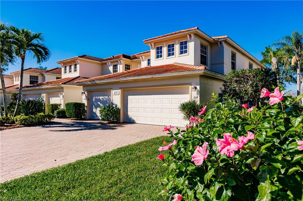 Mediterranean / spanish-style home featuring stucco siding, a garage, decorative driveway, and a tile roof