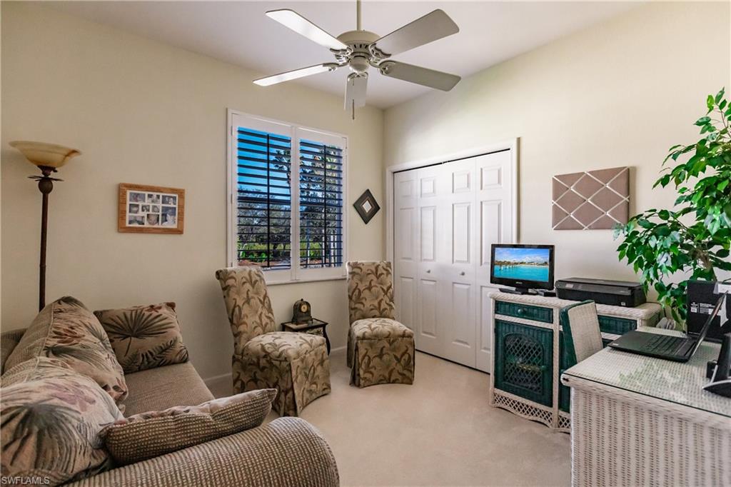Carpeted office space with ceiling fan