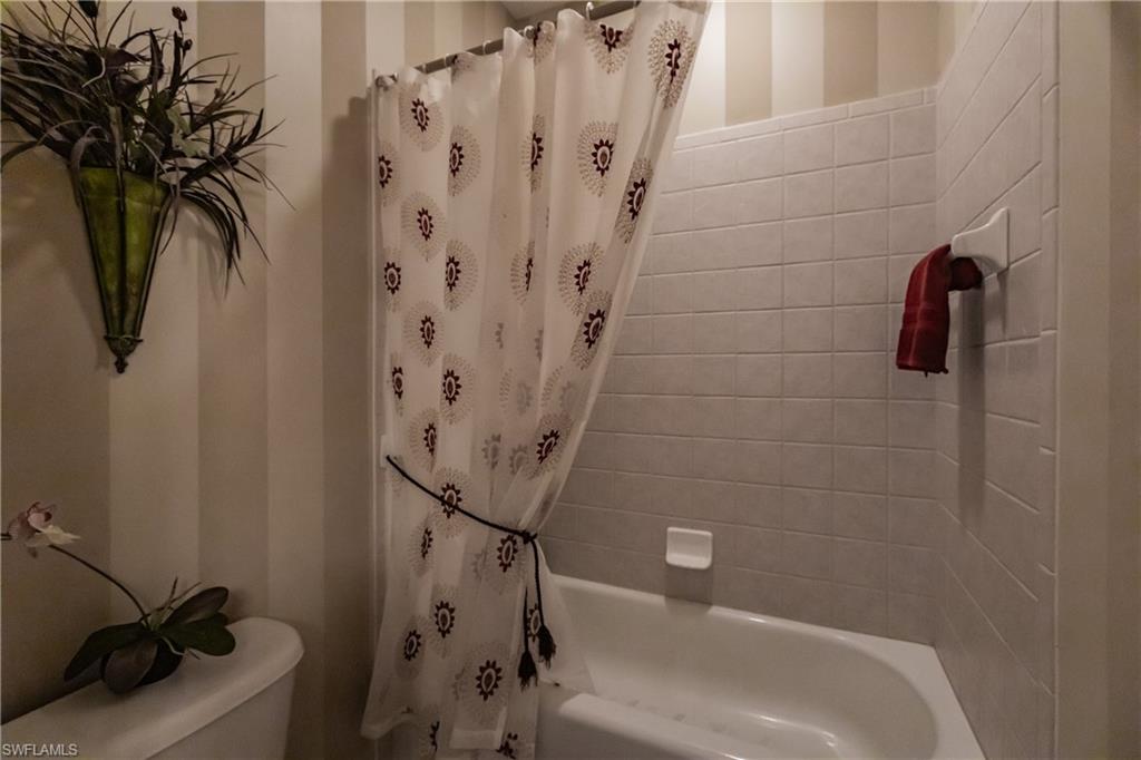 Full bathroom with toilet and shower / bath combo