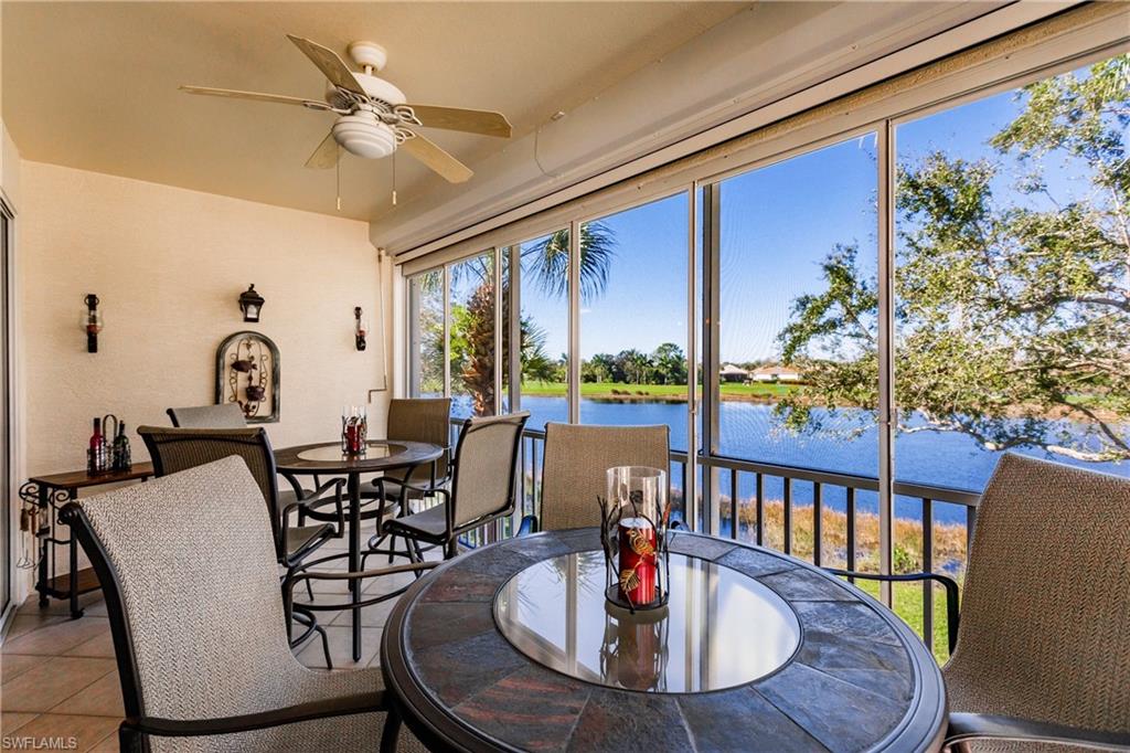Sunroom featuring a water view and tile patterned floors
