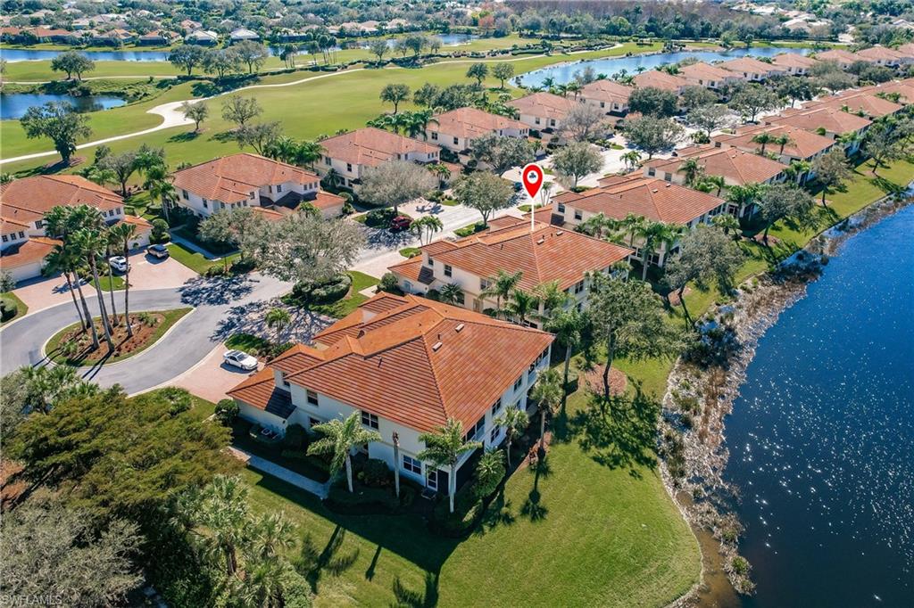Aerial perspective of suburban area with a nearby body of water