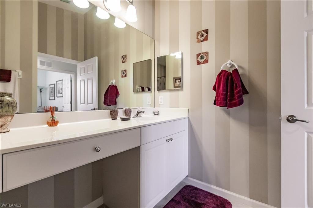 Bathroom featuring vanity and wallpapered walls
