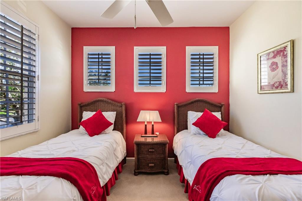 Carpeted bedroom featuring ceiling fan