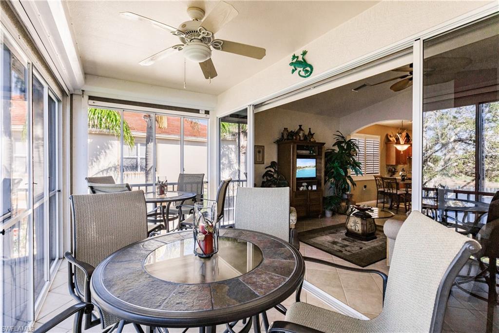 Sunroom / solarium featuring outdoor dining space, a ceiling fan, and plenty of natural light