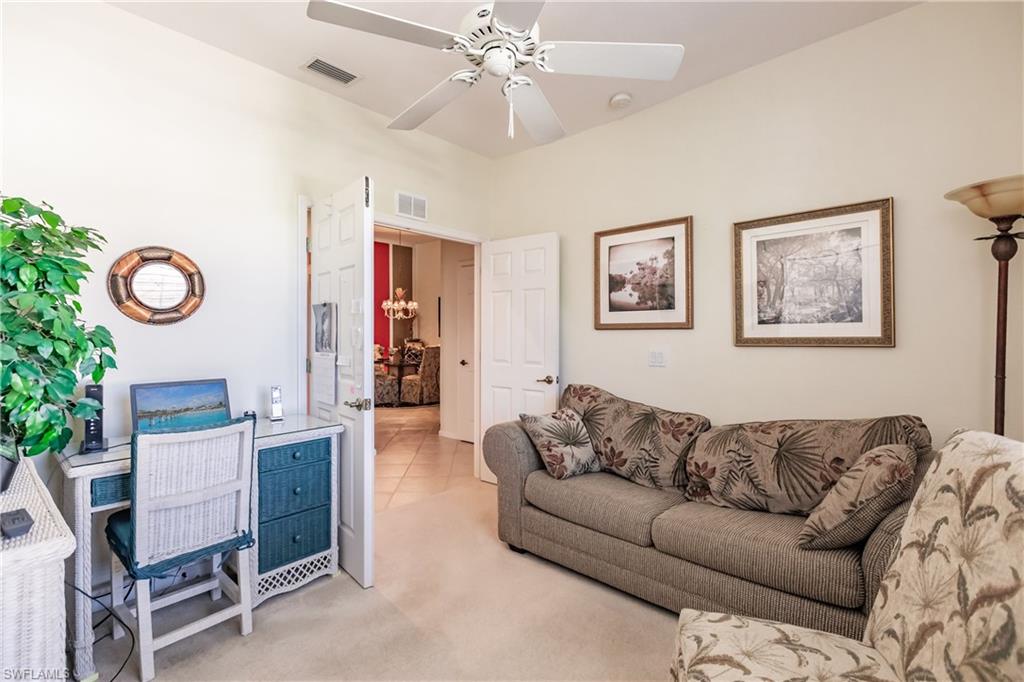 Living area with carpet flooring and a ceiling fan