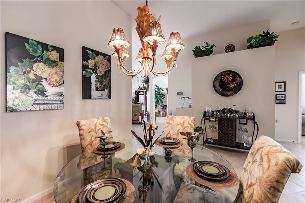 Dining area with a chandelier and light tile patterned flooring