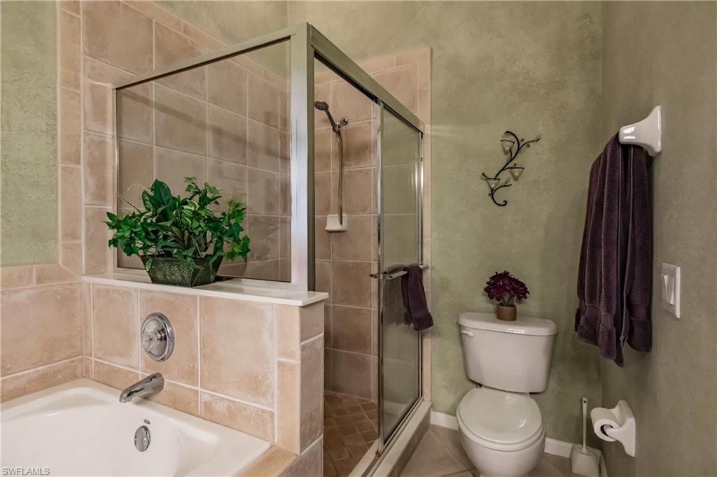 Bathroom with a garden tub, a shower stall, and tile patterned flooring