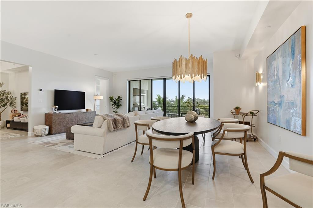 Dining space with a chandelier and baseboards