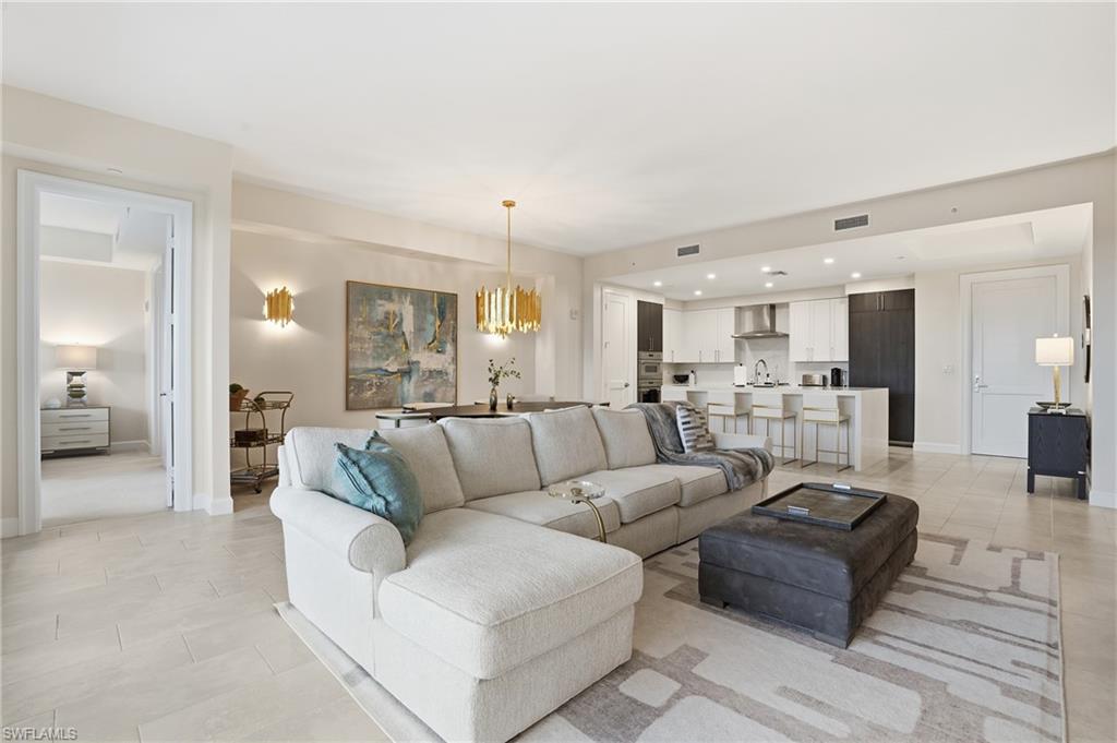 Living room featuring a chandelier, recessed lighting, and light tile patterned flooring