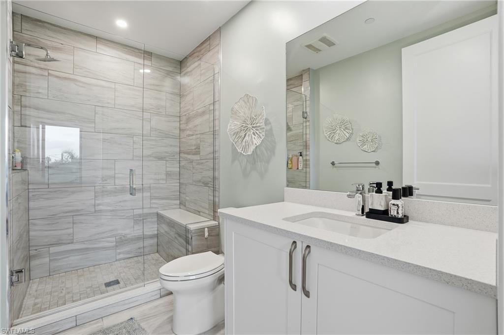 Full bathroom featuring a stall shower and vanity