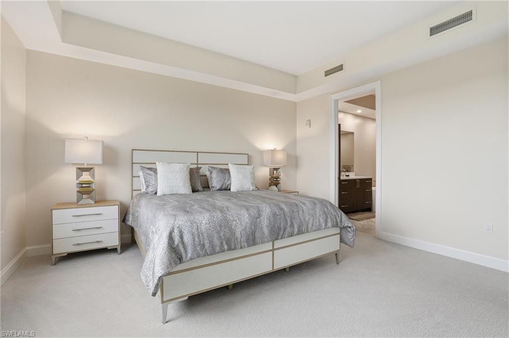 Bedroom with carpet floors and ensuite bath