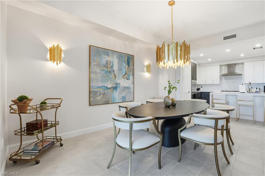 Dining area featuring recessed lighting, a chandelier, and light tile patterned flooring