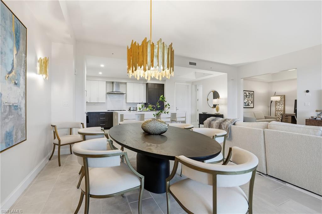 Dining area featuring light tile patterned floors and recessed lighting