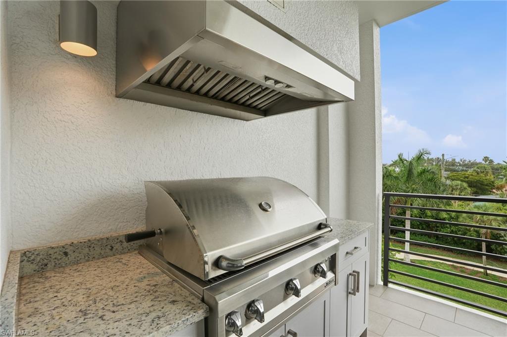 Detailed view of custom range hood and stucco siding