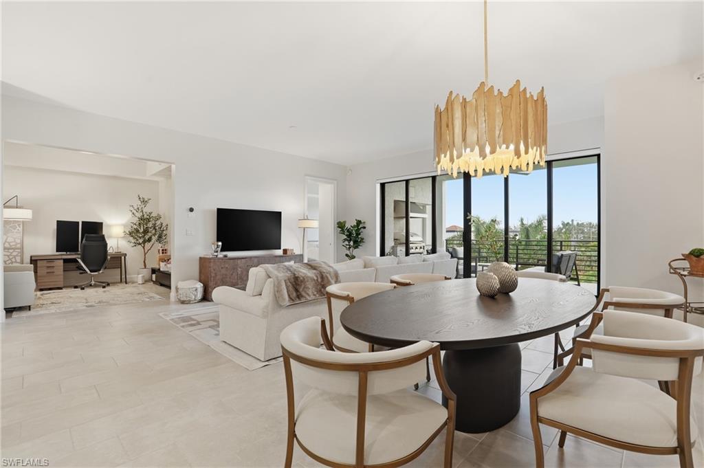 Dining room with a desk and a chandelier