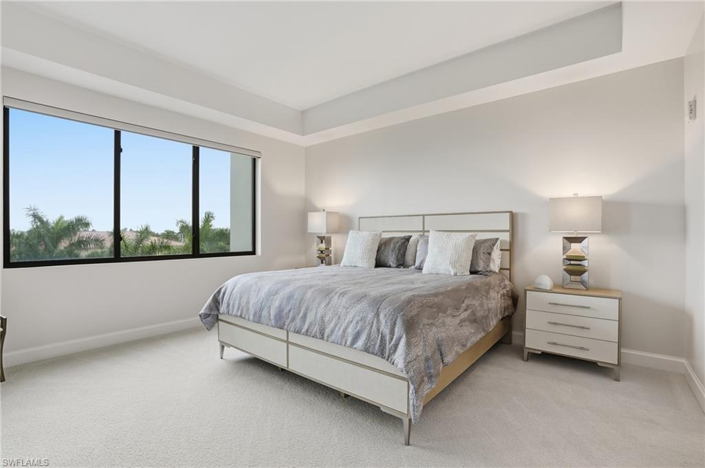 Carpeted bedroom featuring baseboards