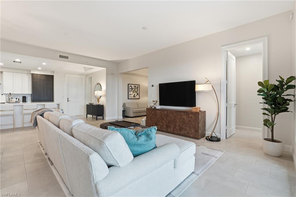 Living area with recessed lighting and light tile patterned floors